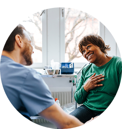 Man and woman sitting down and looking at a laptop