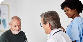 Man in blue shirt, wearing glasses, and talking on a cell phone