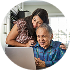 Man and woman looking down at a laptop in the kitchen
