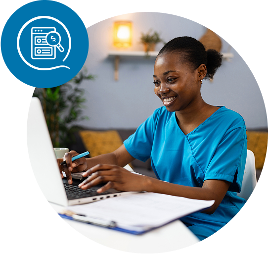 Healthcare provider smiling and typing on a laptop