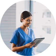 Healthcare provider smiling down at a tablet