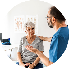 Woman in a gray shirt talking to a healthcare provider
