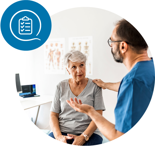 Woman in a gray shirt talking to a healthcare provider